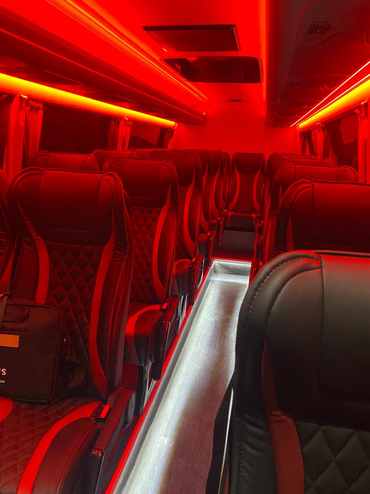Luxury minicoach interior with red ambient lighting